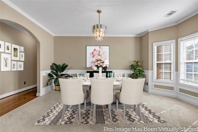 4499 Bellemeade Dr, Douglasville, GA 30135 - carpeted dining area with visible vents, arched walkways, a notable chandelier, and crown molding