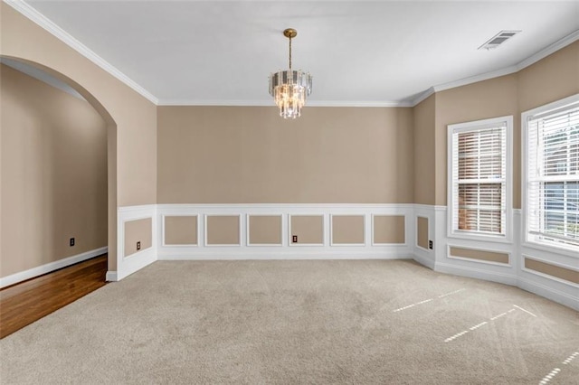 4499 Bellemeade Dr, Douglasville, GA 30135 - carpeted spare room with arched walkways, a notable chandelier, ornamental molding, and visible vents