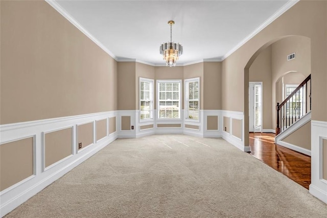 4499 Bellemeade Dr, Douglasville, GA 30135 - unfurnished dining area with a notable chandelier, arched walkways, ornamental molding, carpet flooring, and visible vents