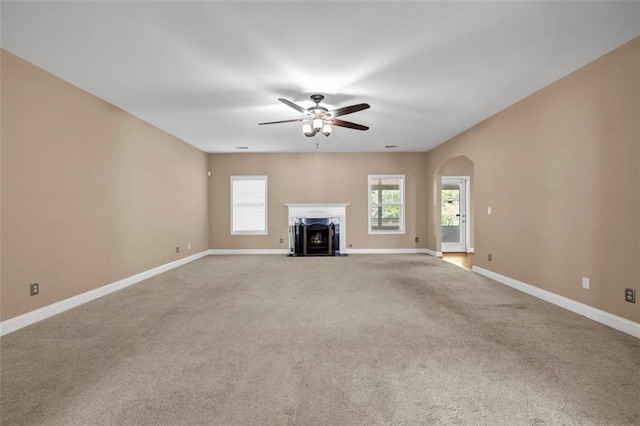 4499 Bellemeade Dr, Douglasville, GA 30135 - unfurnished living room with arched walkways, carpet, a ceiling fan, and baseboards