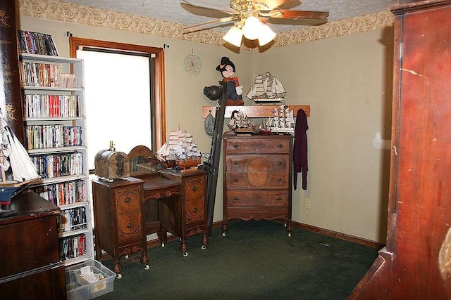 carpeted office space featuring a textured ceiling and ceiling fan