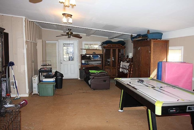 playroom featuring ceiling fan, vaulted ceiling, and concrete floors