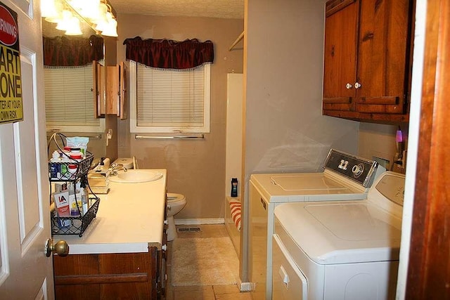 laundry area with washer and dryer and sink