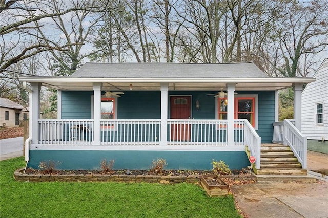 bungalow-style home featuring a porch, ceiling fan, and a front lawn