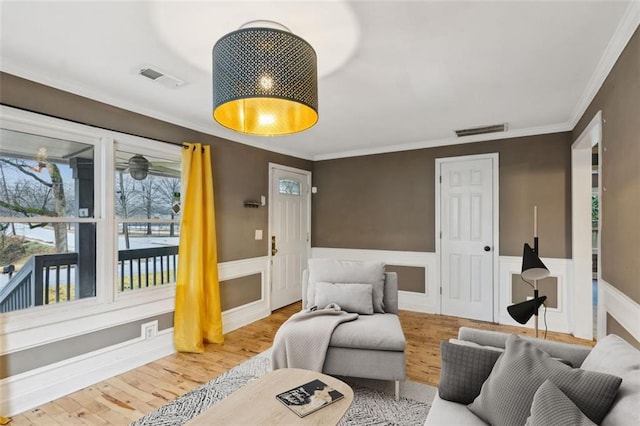 living room featuring hardwood / wood-style floors and ornamental molding