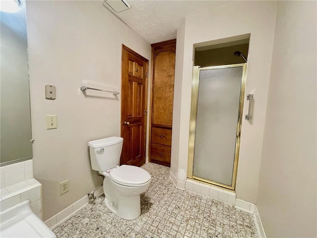 full bath featuring toilet, baseboards, a textured ceiling, and a stall shower