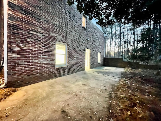 view of home's exterior featuring a patio area and brick siding