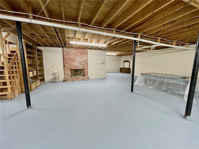 below grade area with a brick fireplace