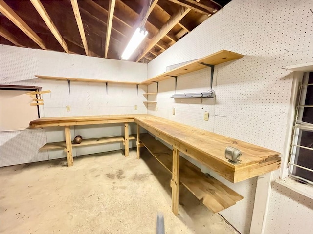 unfinished below grade area featuring a workshop area