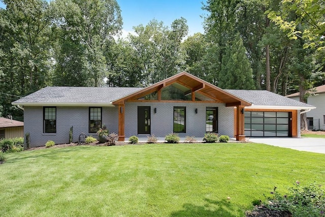 view of front of property with a garage and a front lawn