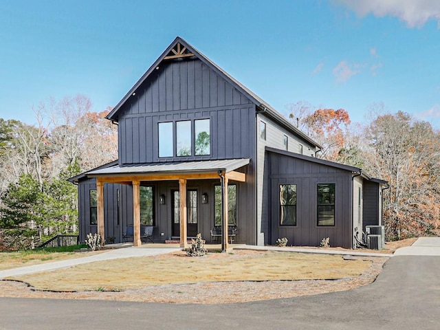 modern inspired farmhouse featuring central AC unit and covered porch