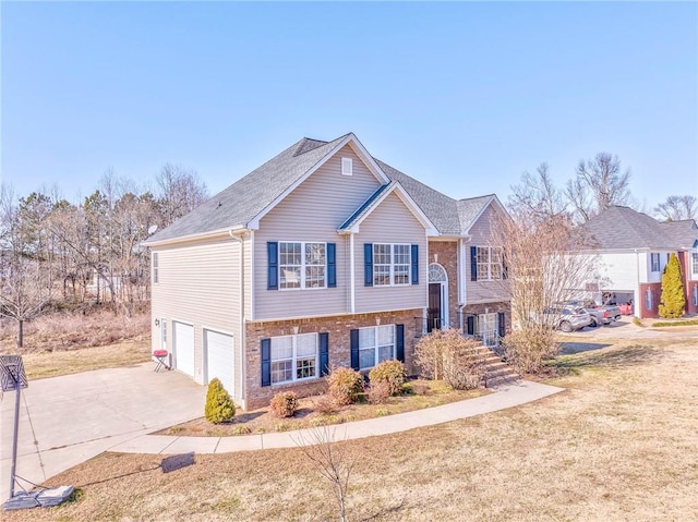 split foyer home featuring a garage and a front lawn