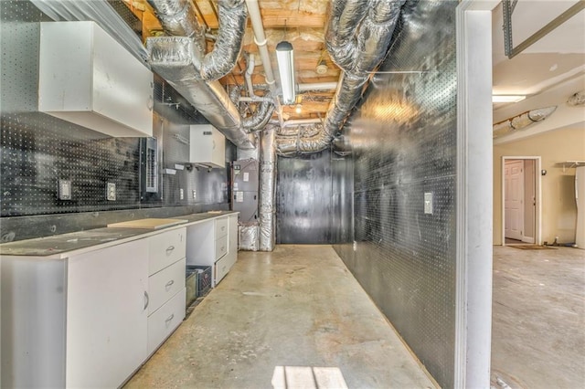 kitchen with water heater and white cabinets