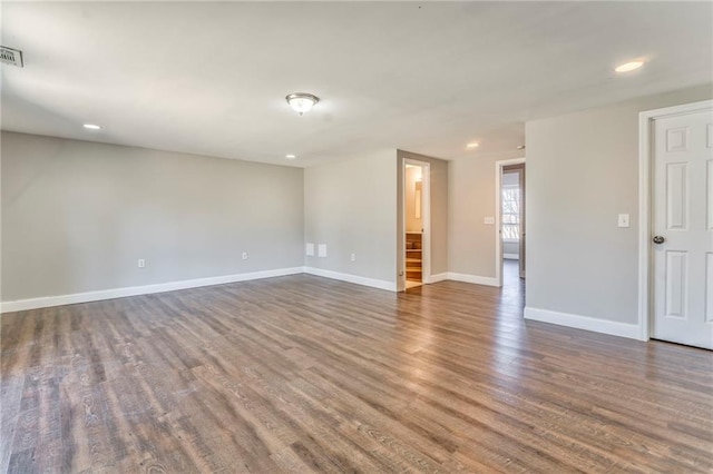 spare room with dark wood-type flooring