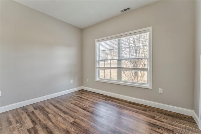 unfurnished room with dark hardwood / wood-style flooring