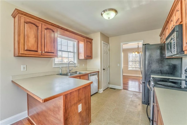 kitchen with stainless steel appliances, a kitchen bar, sink, and a wealth of natural light