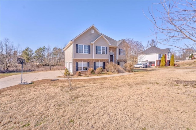 view of front of property featuring a garage and a front yard