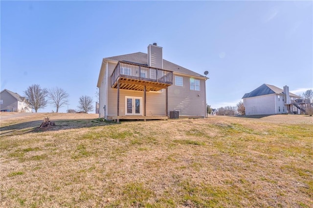 rear view of house featuring a wooden deck, a yard, and central AC unit