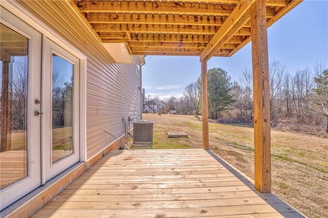 wooden terrace with a yard and central AC unit