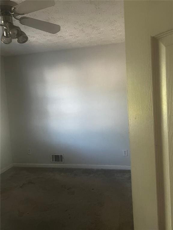 spare room featuring a textured ceiling and ceiling fan