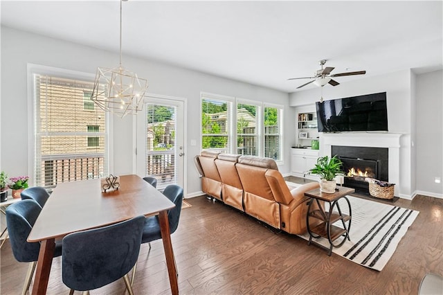 350 Provenance Dr, Atlanta, GA 30328 - living area featuring dark wood-style flooring, a warm lit fireplace, a chandelier, and ceiling fan