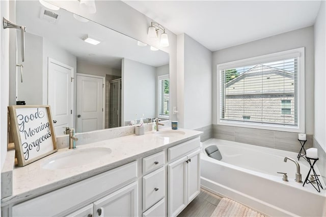 350 Provenance Dr, Atlanta, GA 30328 - full bath with double vanity, a bath, a shower stall, and wood finished floors