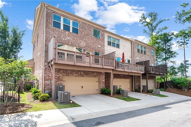 350 Provenance Dr, Atlanta, GA 30328 - back of property with brick siding, an attached garage, and driveway