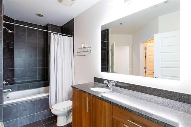 full bath featuring visible vents, toilet, tile patterned floors, tiled shower / bath, and vanity