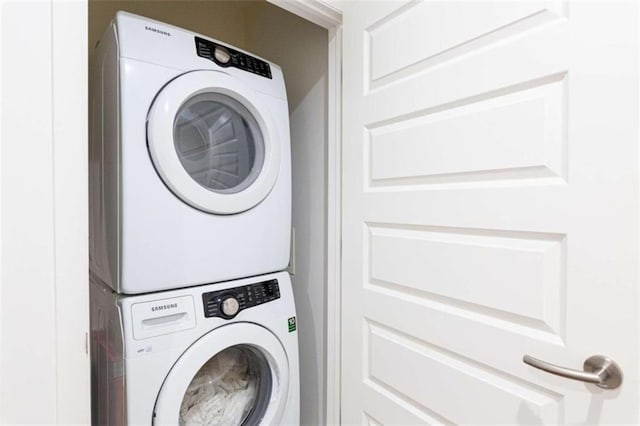 laundry room featuring laundry area and stacked washer / drying machine