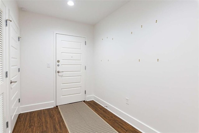 doorway with dark wood-style floors, recessed lighting, and baseboards