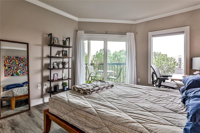 bedroom featuring access to exterior, multiple windows, wood finished floors, and ornamental molding