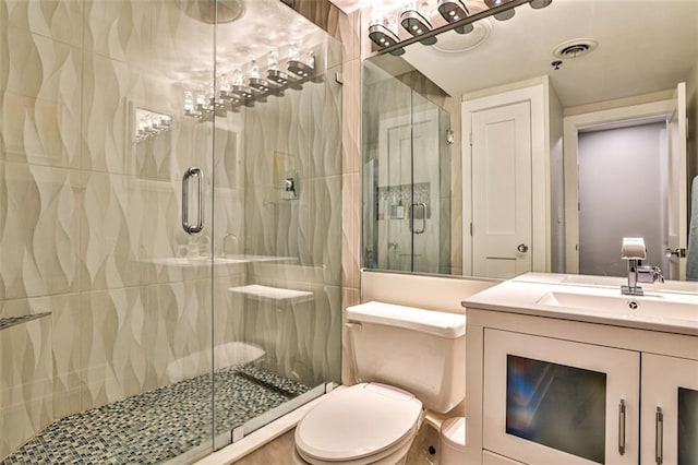 full bath with vanity, toilet, visible vents, and a stall shower