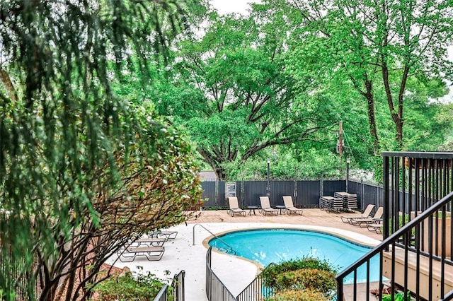 pool with a patio and fence