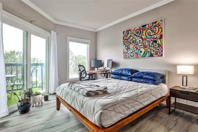 bedroom featuring access to exterior, crown molding, and wood finished floors