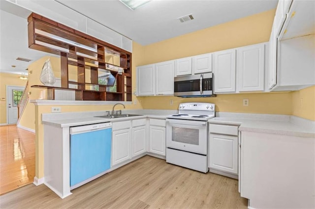 kitchen with light wood-type flooring, white cabinets, and stainless steel appliances