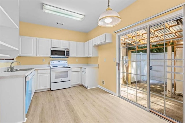 kitchen featuring white electric range oven, light wood-type flooring, sink, and white cabinetry