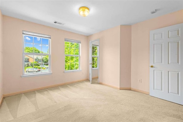 unfurnished room featuring light colored carpet