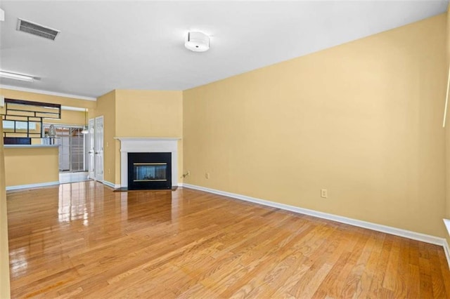 unfurnished living room with light hardwood / wood-style flooring