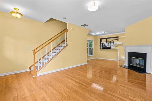 unfurnished living room with light hardwood / wood-style floors