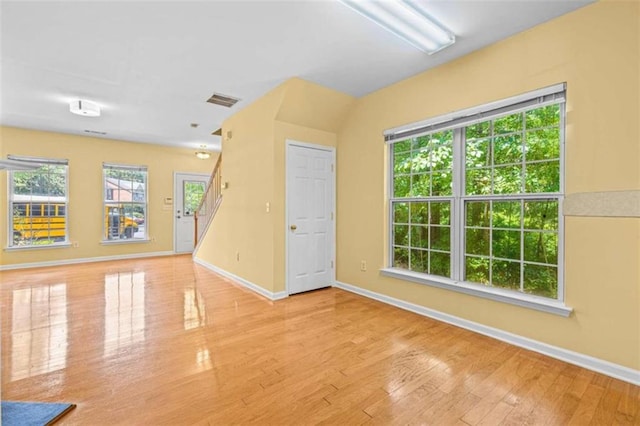 empty room featuring light hardwood / wood-style flooring and a wealth of natural light