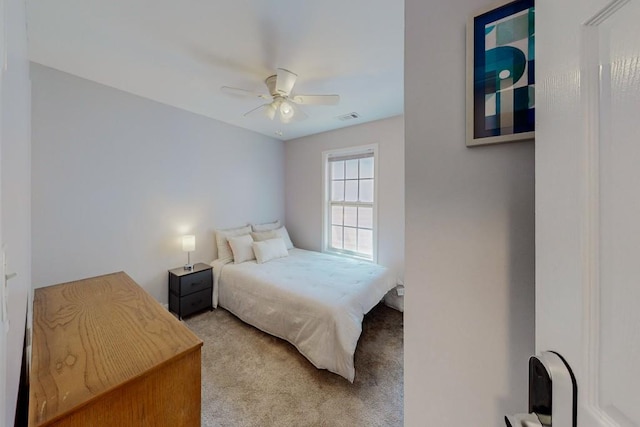 bedroom with visible vents, light carpet, and ceiling fan