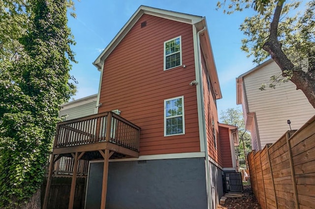 back of house with a deck and fence