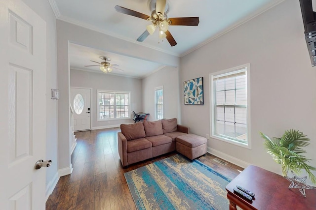 living area featuring dark wood-type flooring, baseboards, and ornamental molding