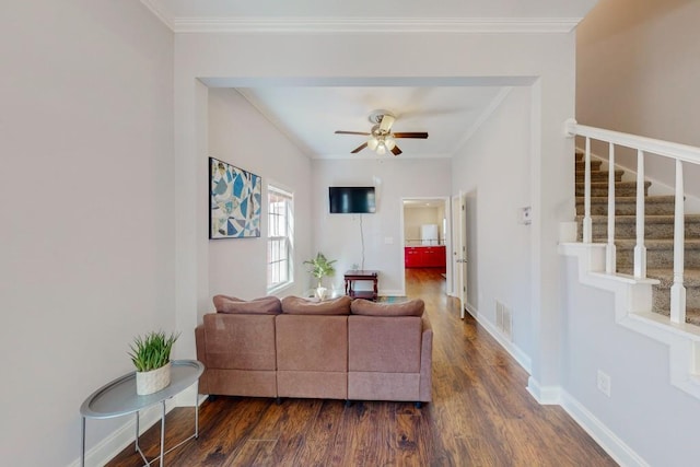 living area with visible vents, stairway, crown molding, baseboards, and dark wood-style flooring