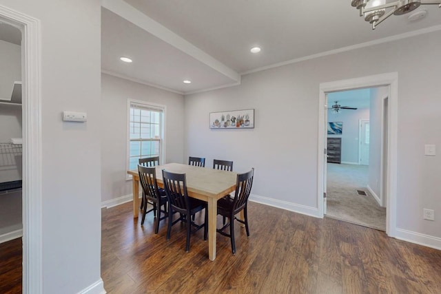 dining area featuring baseboards, dark wood-style flooring, and ornamental molding