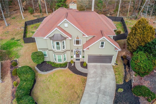 view of front of house with a garage and a front yard