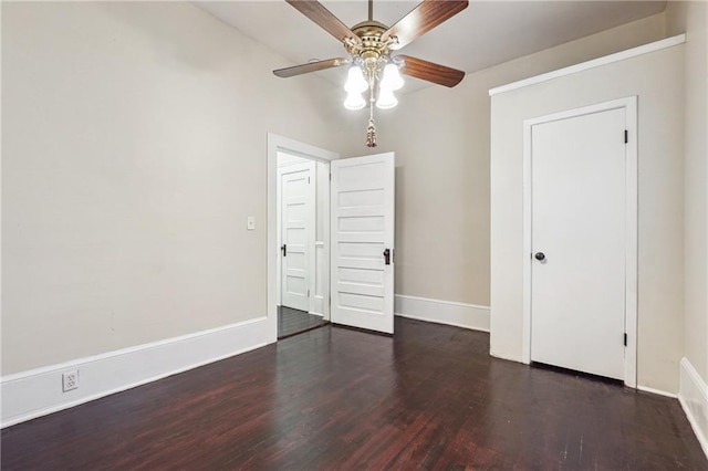 unfurnished room featuring a ceiling fan, baseboards, and wood finished floors