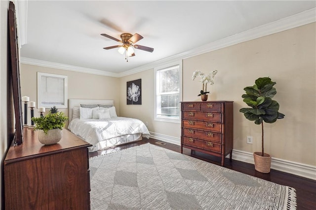 bedroom featuring ceiling fan, ornamental molding, wood finished floors, and baseboards