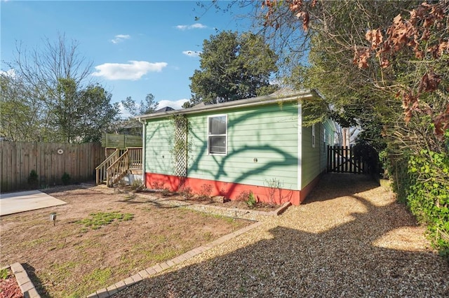 view of outbuilding featuring fence