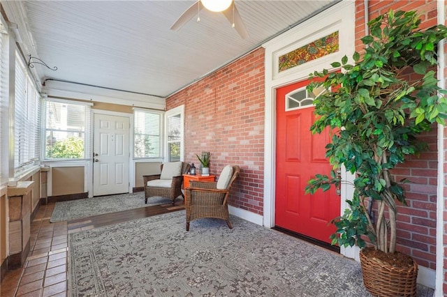 sunroom featuring ceiling fan